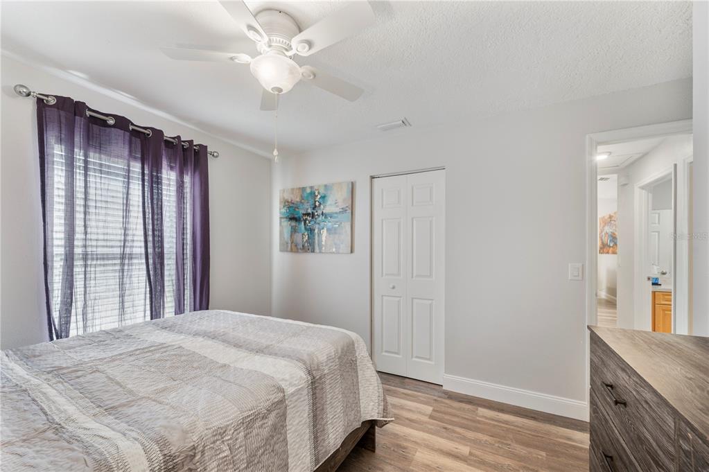 1106 Lakewood Road Lakeland, FL 33805 - Photo 19 of 27 a bedroom with a bed and a chandelier
