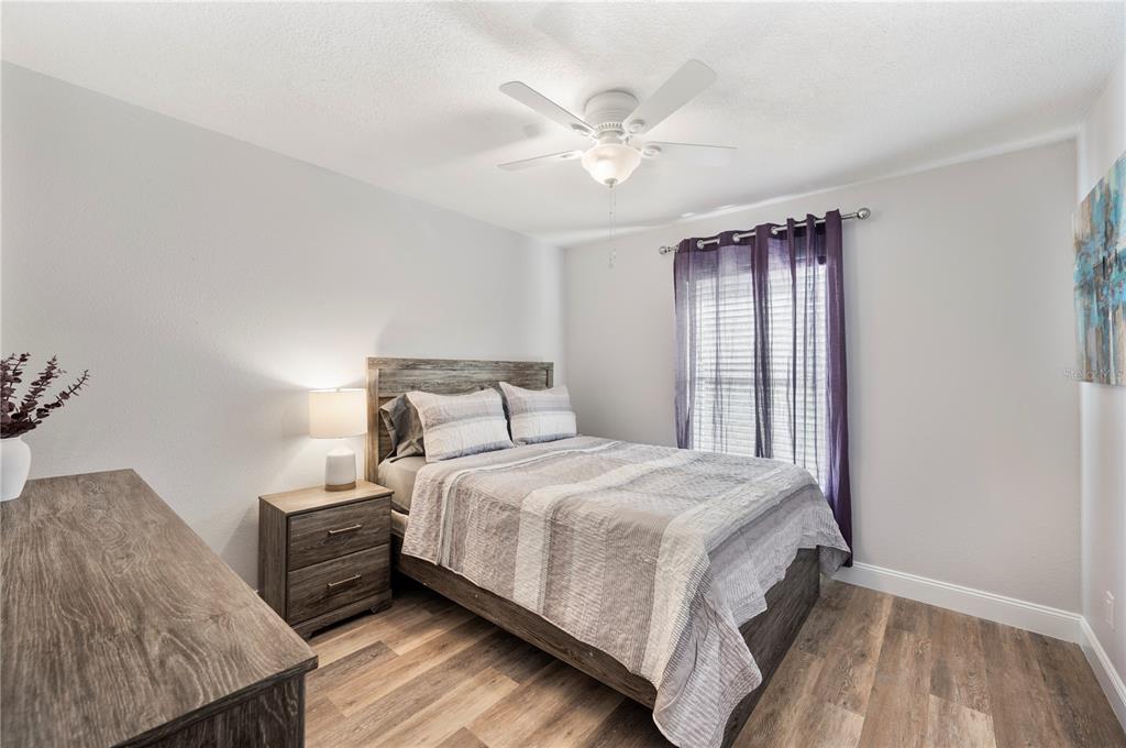 1106 Lakewood Road Lakeland, FL 33805 - Photo 20 of 27 a bedroom with a bed and a chandelier