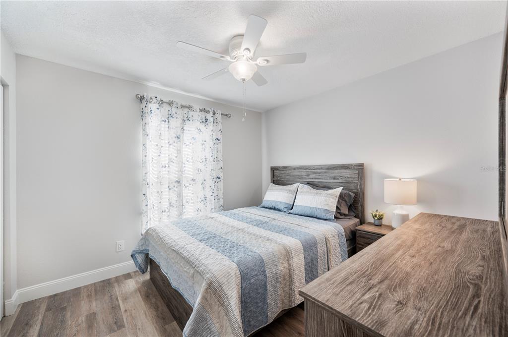 1106 Lakewood Road Lakeland, FL 33805 - Photo 22 of 27 a bedroom with two beds and a chandelier