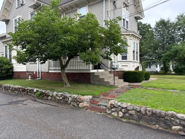 a view of a house with a garden and pathway
