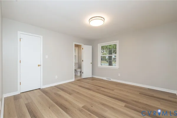 a view of a room with wooden floor and window