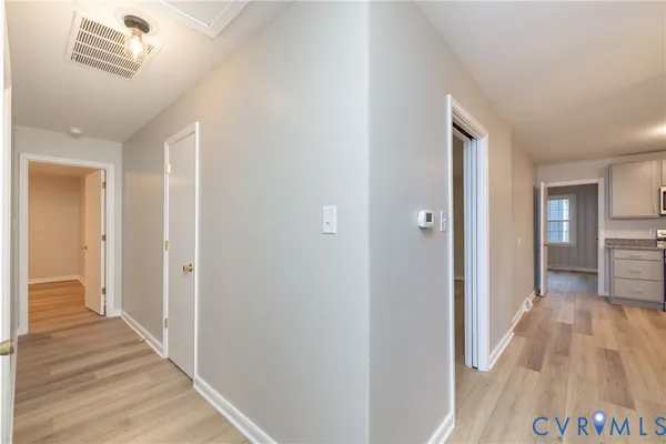 a view of a hallway with wooden floor
