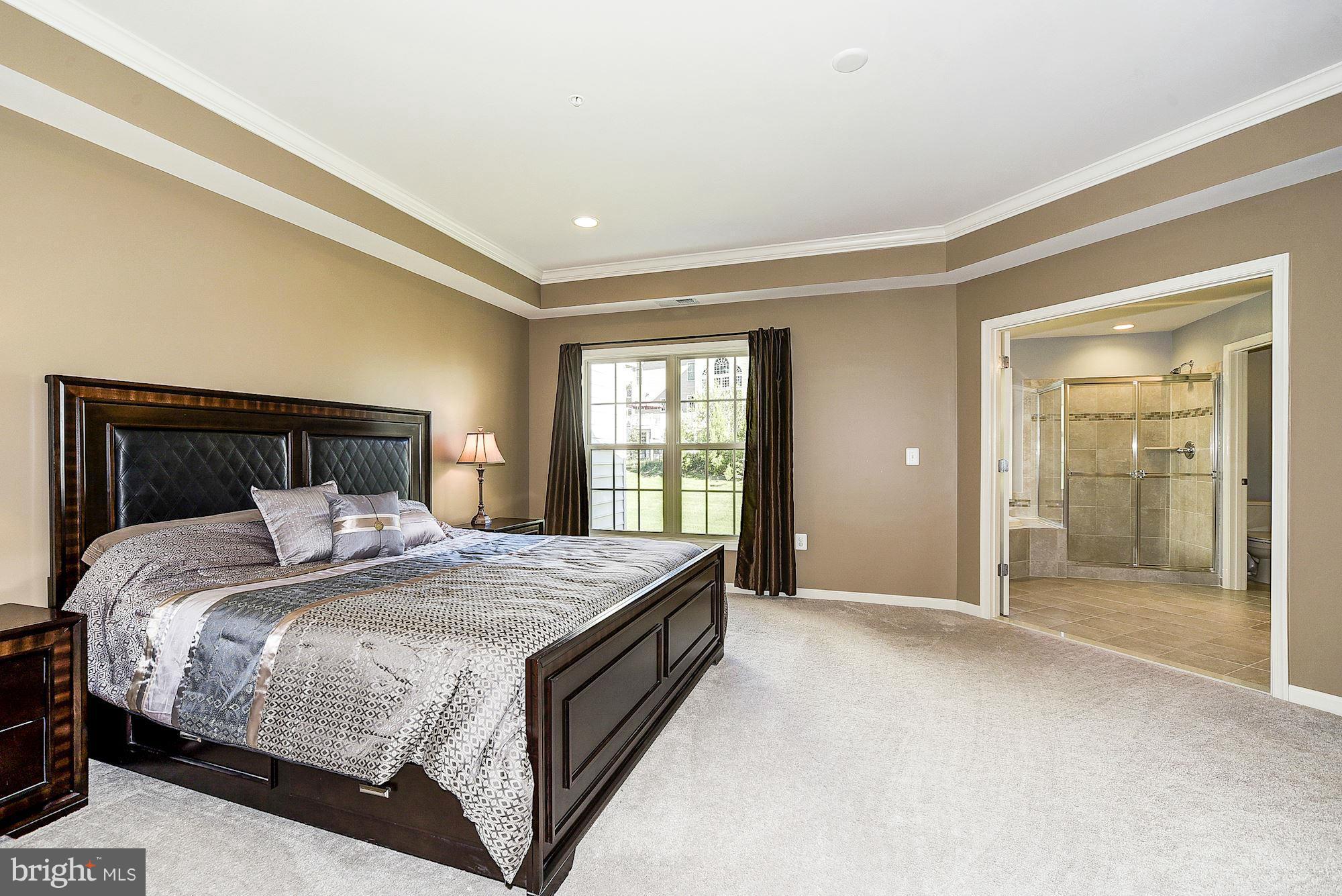 1525 Rabbit Hollow Place Silver Spring, MD 20906 - Photo 14 of 30 a spacious bedroom with a bed and a window