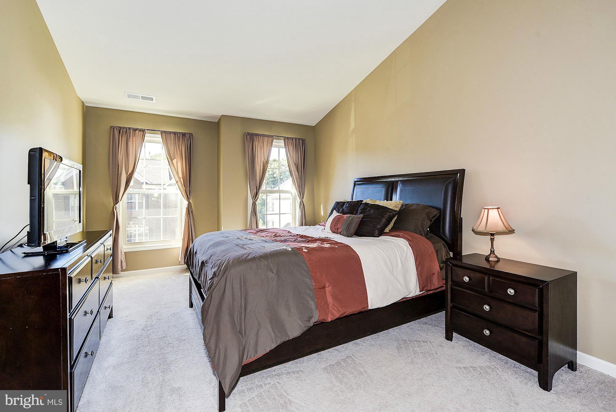 1525 Rabbit Hollow Place Silver Spring, MD 20906 - Photo 18 of 30 a bedroom with a bed and a flat tv screen on dresser