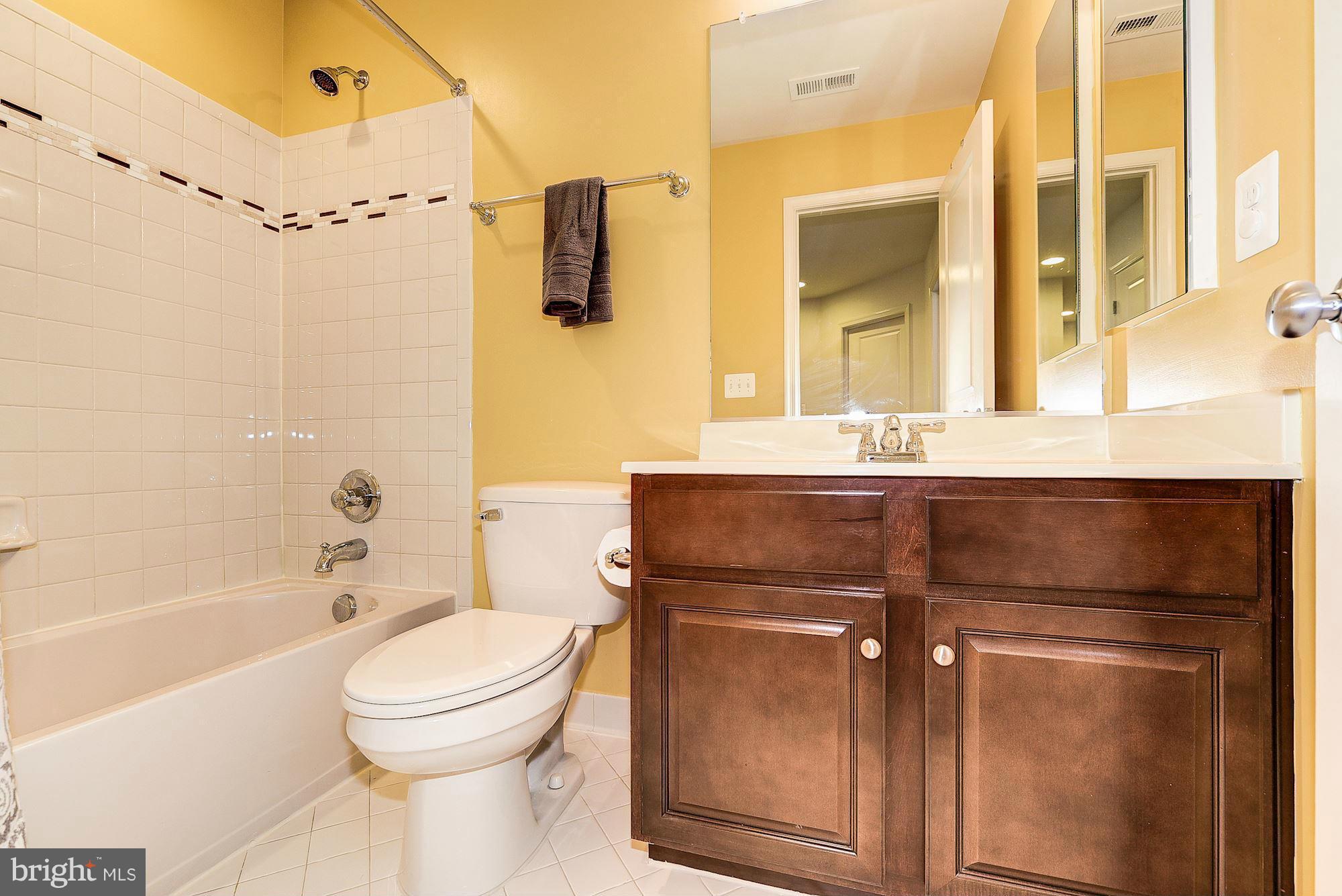 1525 Rabbit Hollow Place Silver Spring, MD 20906 - Photo 19 of 30 a bathroom with a granite countertop sink toilet and shower