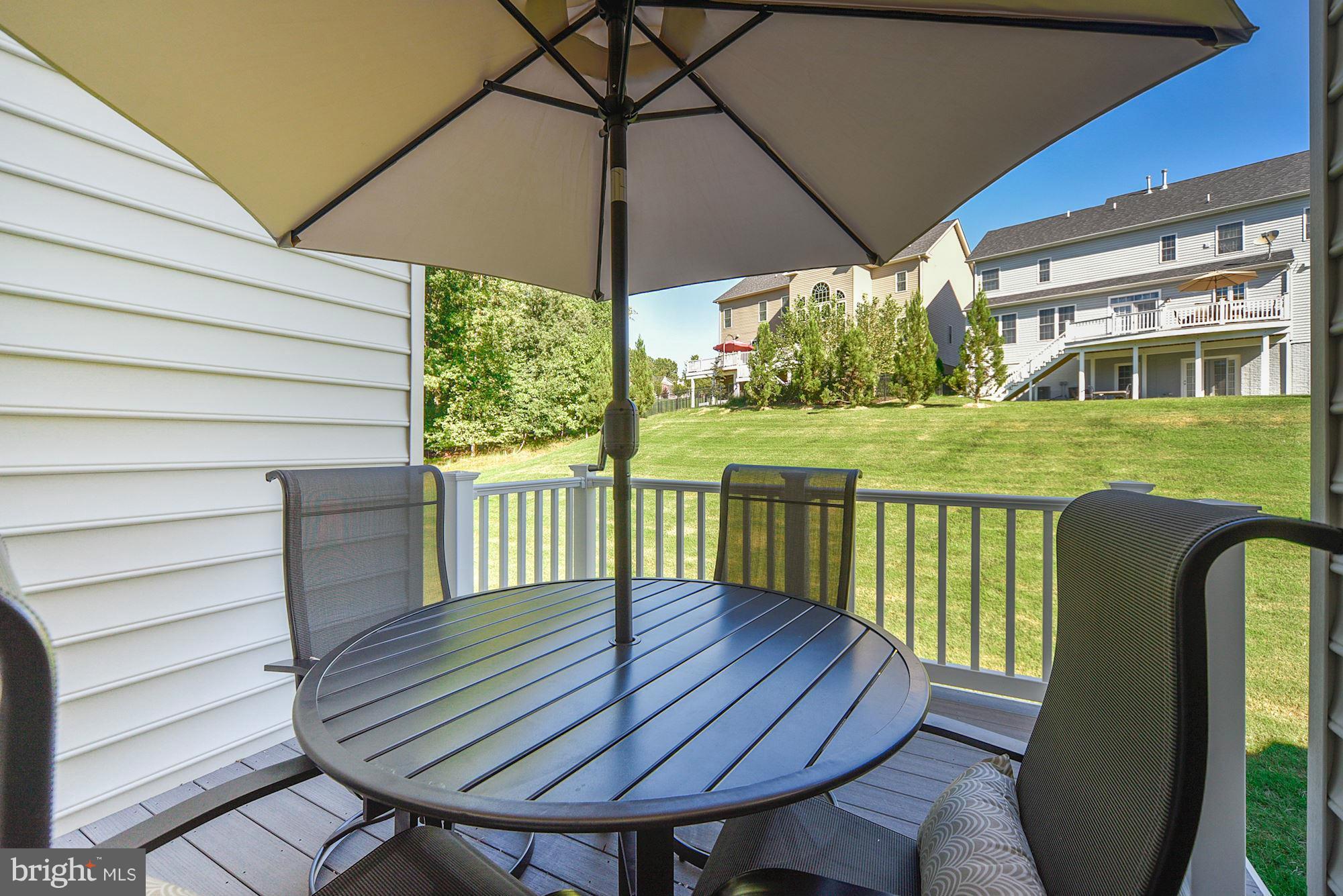 1525 Rabbit Hollow Place Silver Spring, MD 20906 - Photo 25 of 30 a view of a deck with a table and chairs under an umbrella