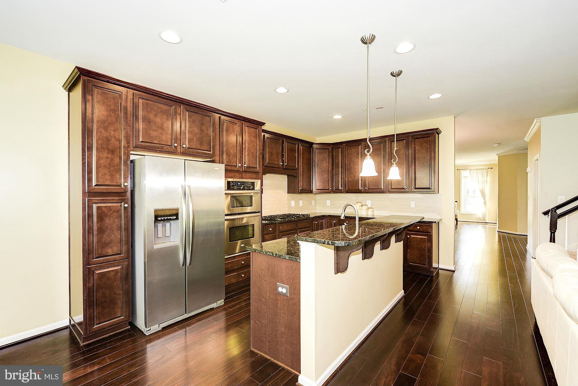 1525 Rabbit Hollow Place Silver Spring, MD 20906 - Photo 10 of 30 a kitchen with stainless steel appliances granite countertop a refrigerator a sink a stove and a refrigerator