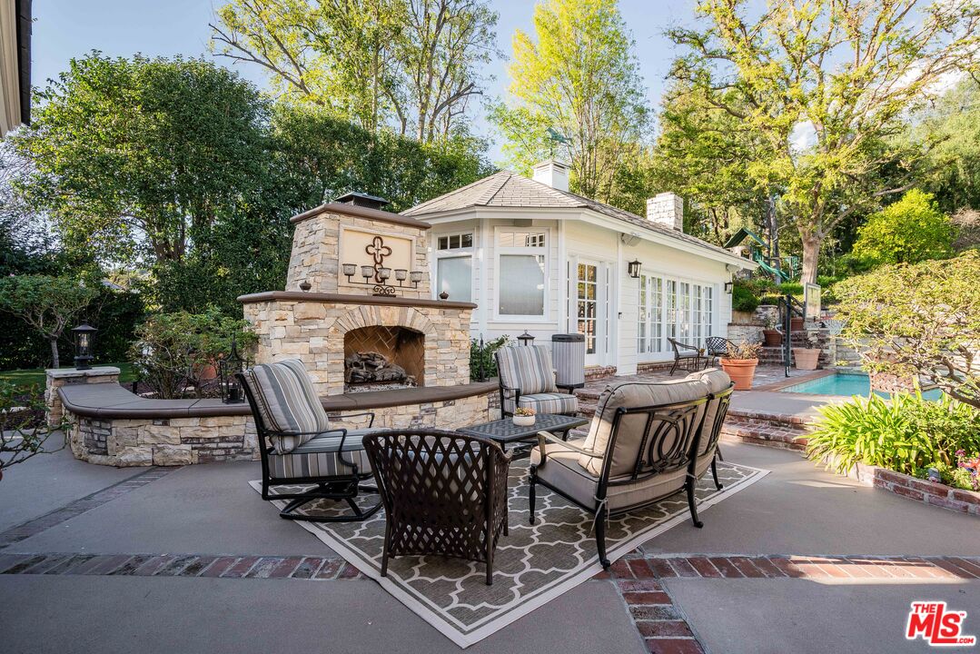 23939 Long Valley Road Hidden Hills, CA 91302 - Photo 12 of 61 a view of a patio with table and chairs and potted plants