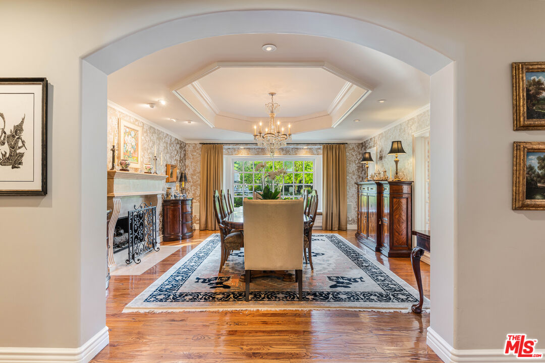 23939 Long Valley Road Hidden Hills, CA 91302 - Photo 21 of 61 a living room with fireplace furniture and a dining table