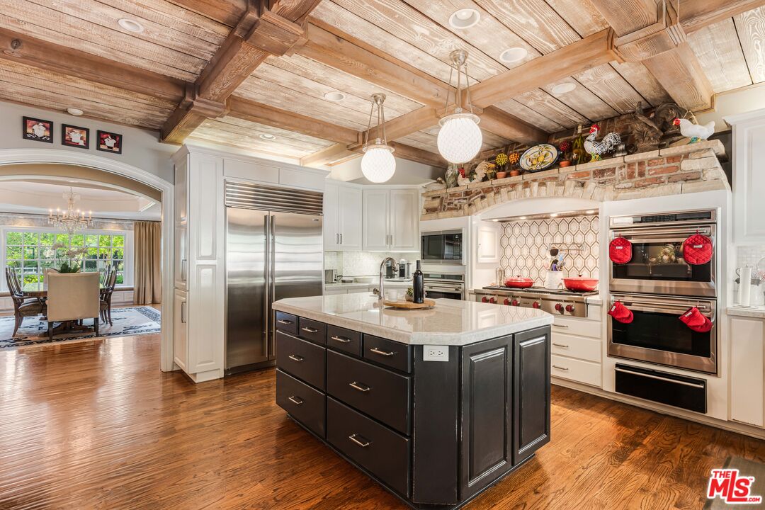 23939 Long Valley Road Hidden Hills, CA 91302 - Photo 25 of 61 a kitchen with stainless steel appliances granite countertop a sink and cabinets