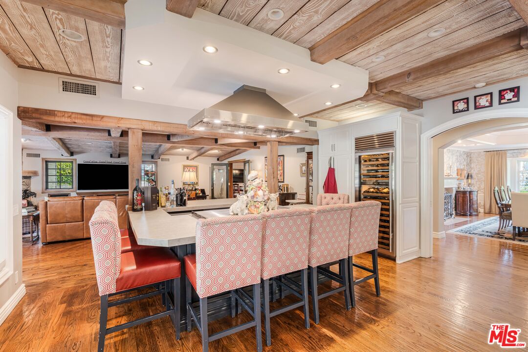23939 Long Valley Road Hidden Hills, CA 91302 - Photo 29 of 61 a view of a dining room with furniture wooden floor and a rug