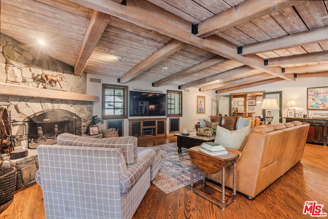 23939 Long Valley Road Hidden Hills, CA 91302 - Photo 31 of 61 a living room with furniture and a flat screen tv