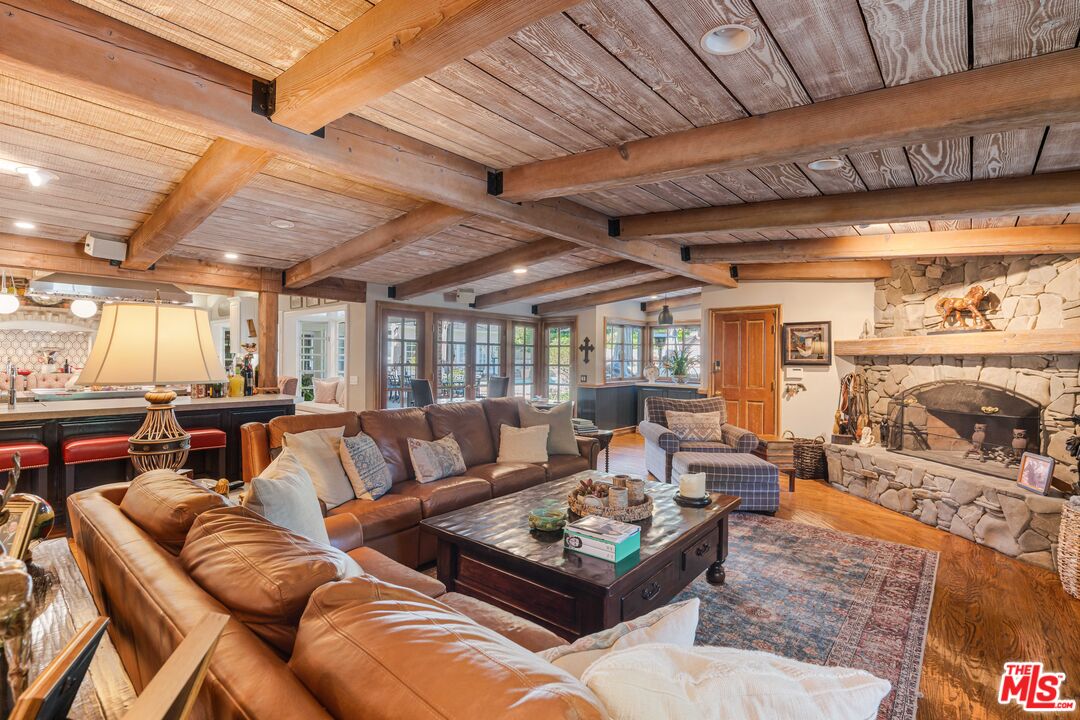 23939 Long Valley Road Hidden Hills, CA 91302 - Photo 32 of 61 a living room with furniture and a chandelier