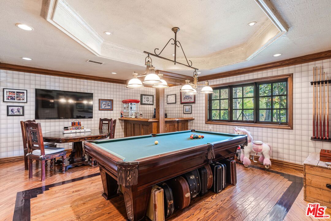 23939 Long Valley Road Hidden Hills, CA 91302 - Photo 33 of 61 a room with furniture and a flat screen tv