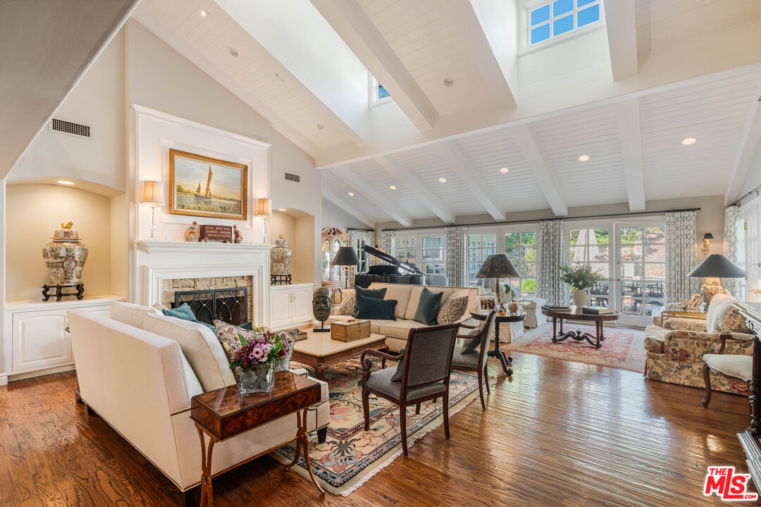 23939 Long Valley Road Hidden Hills, CA 91302 - Photo 34 of 61 a living room with fireplace furniture and a wooden floor