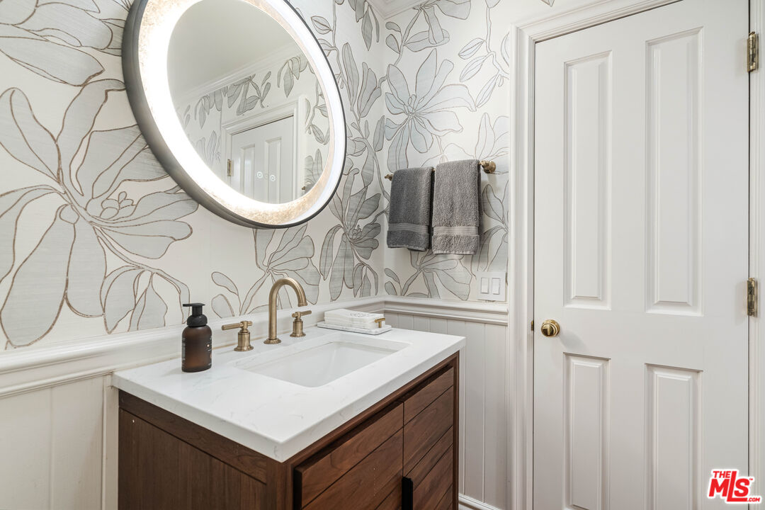 23939 Long Valley Road Hidden Hills, CA 91302 - Photo 39 of 61 a bathroom with a sink and a mirror
