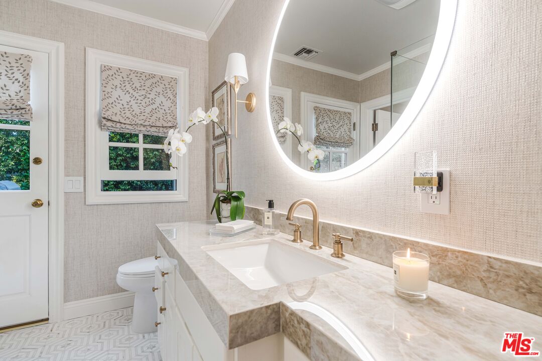 23939 Long Valley Road Hidden Hills, CA 91302 - Photo 43 of 61 a bathroom with a sink a toilet and a mirror