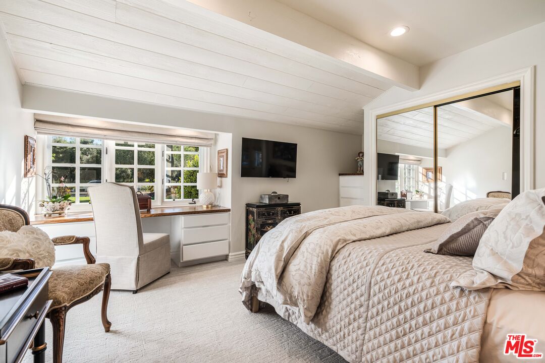 23939 Long Valley Road Hidden Hills, CA 91302 - Photo 45 of 61 a bedroom with a large bed and a flat tv screen