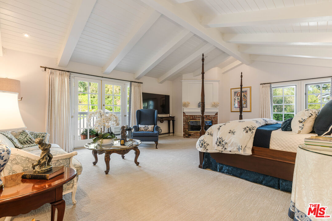 23939 Long Valley Road Hidden Hills, CA 91302 - Photo 51 of 61 a living room with furniture large windows and a flat screen tv