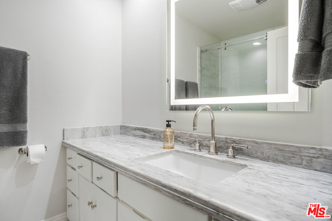 23939 Long Valley Road Hidden Hills, CA 91302 - Photo 56 of 61 a bathroom with a sink and a mirror