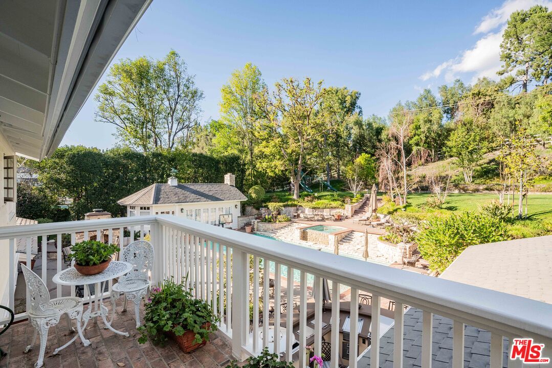 23939 Long Valley Road Hidden Hills, CA 91302 - Photo 57 of 61 a view of a balcony with chairs and potted plants