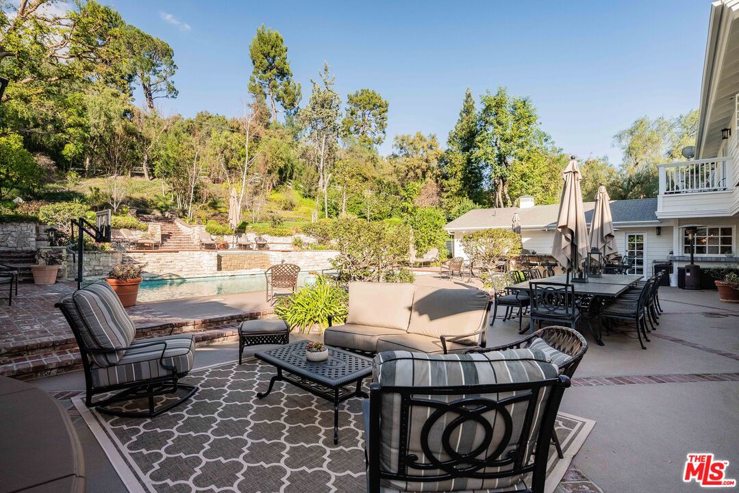 23939 Long Valley Road Hidden Hills, CA 91302 - Photo 9 of 61 a view of a patio with table and chairs and potted plants