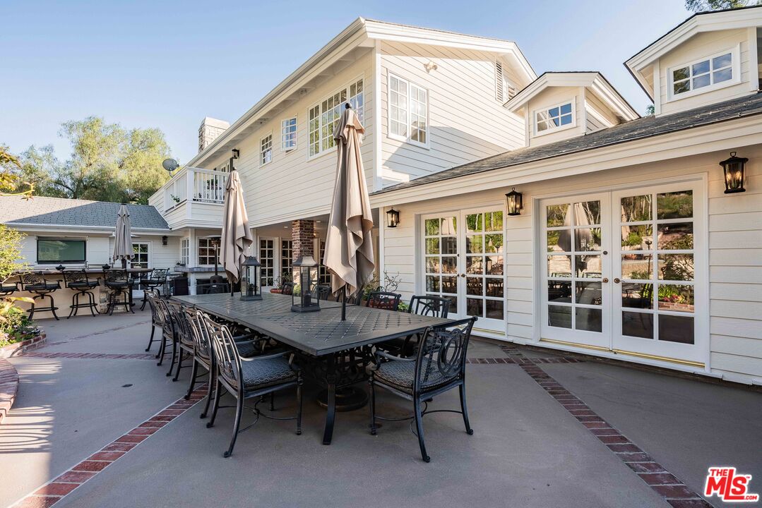23939 Long Valley Road Hidden Hills, CA 91302 - Photo 10 of 61 a view of a house with a table and chairs