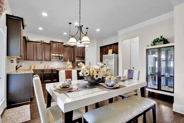 a kitchen with kitchen island a dining table and chairs