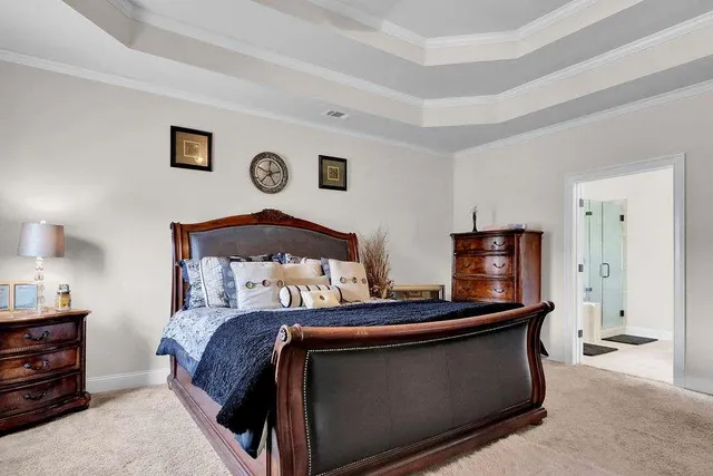 a bedroom with a bed and a lamp on table