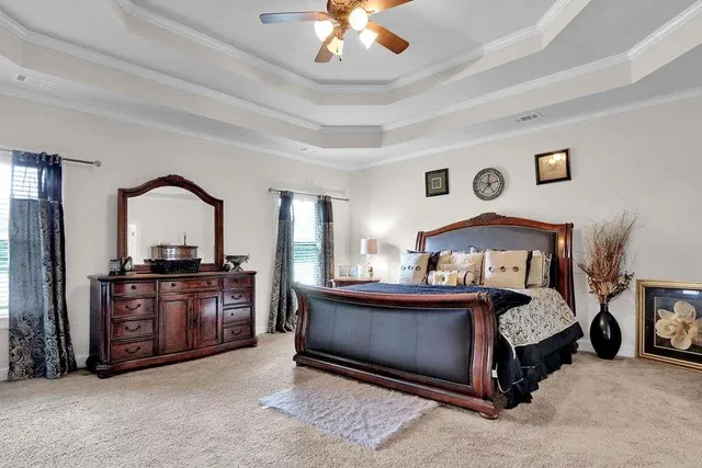 a bedroom with a bed and a chandelier
