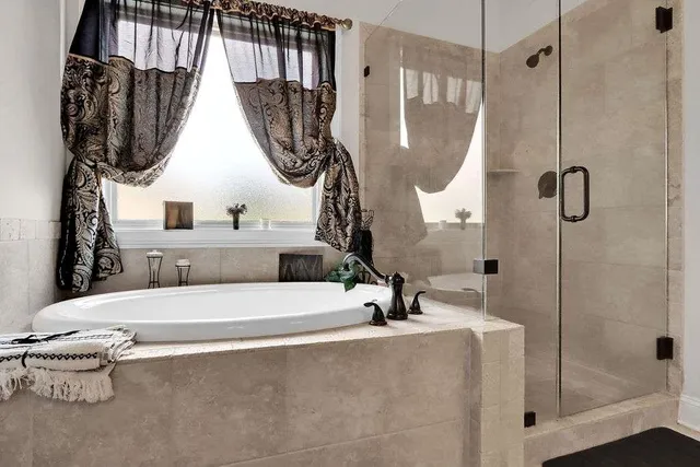 a bathroom with a tub sink and mirror