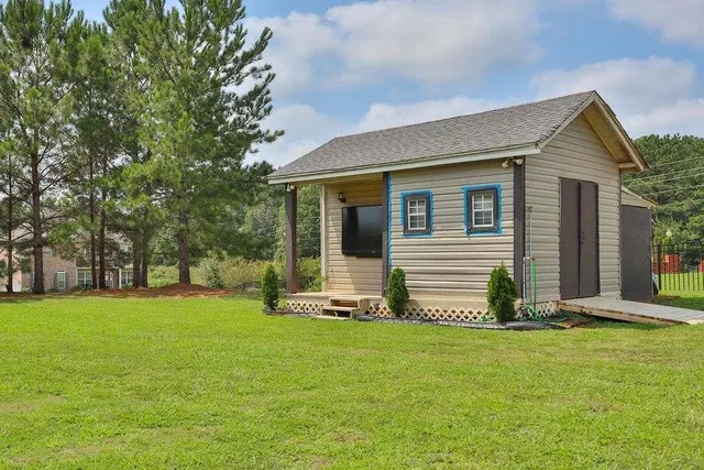a front view of house with a garden