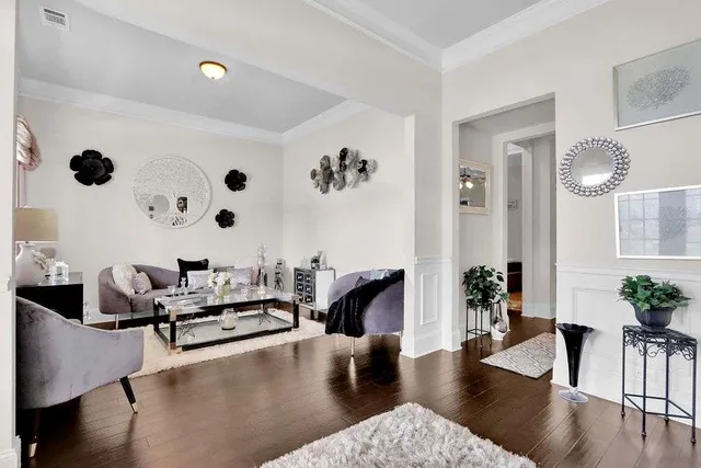 a living room with furniture and wooden floor
