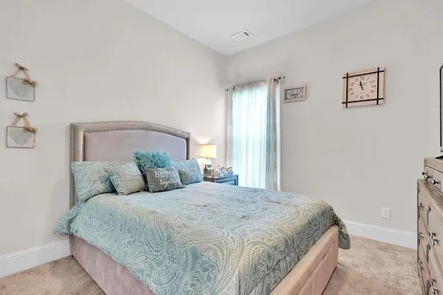 a bedroom with a large bed and a window