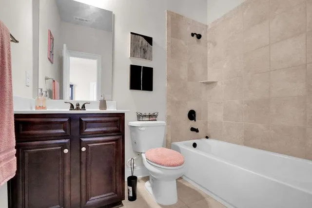 a bathroom with a sink toilet vanity and bathtub