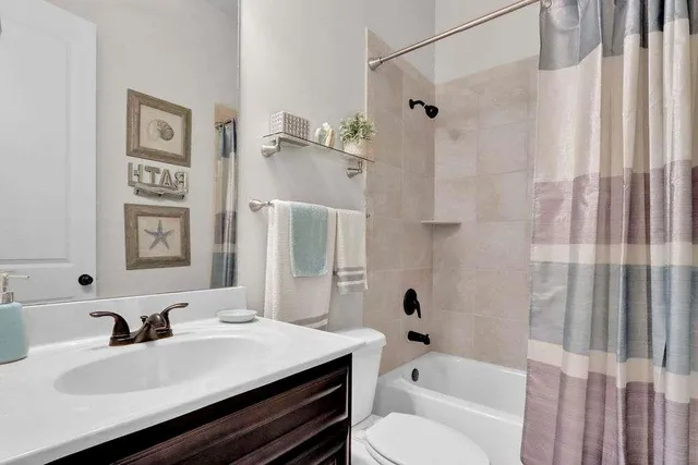 a bathroom with a sink toilet tub and shower