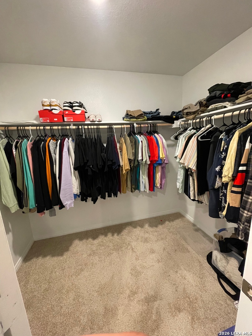 226 Evergreen Sumac Loop Kyle, TX 78640 - Photo 22 of 37 a view of walk in closet with clothes and shoes