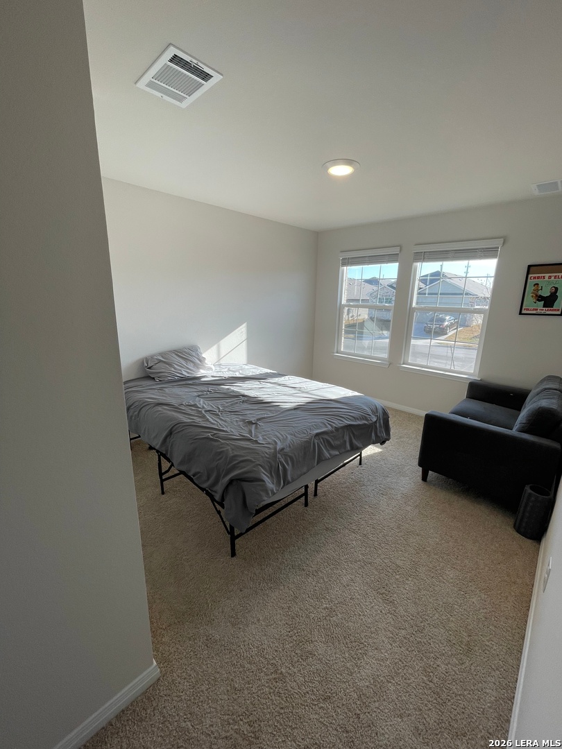 226 Evergreen Sumac Loop Kyle, TX 78640 - Photo 26 of 37 a bedroom with a bed and a couch