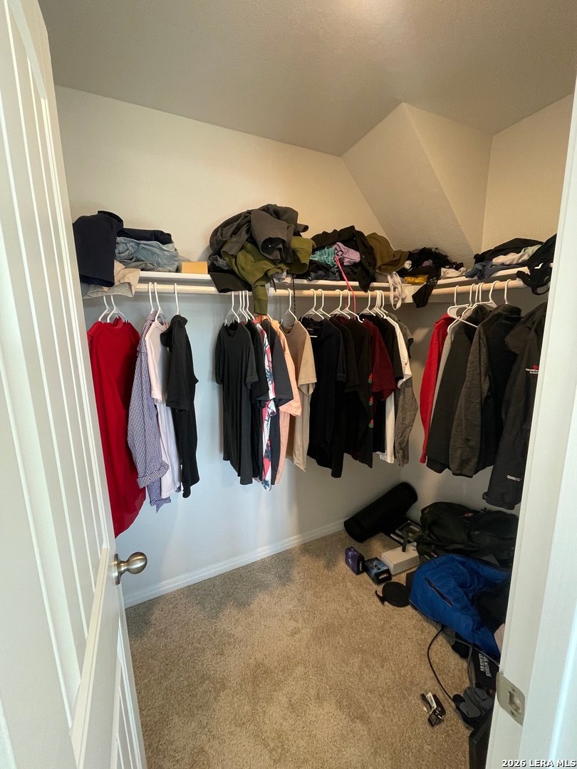 226 Evergreen Sumac Loop Kyle, TX 78640 - Photo 27 of 37 a view of walk in closet with clothes and shoes