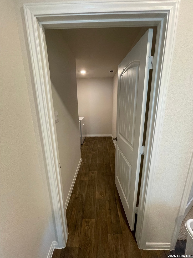 226 Evergreen Sumac Loop Kyle, TX 78640 - Photo 30 of 37 a view of a hallway with wooden floor