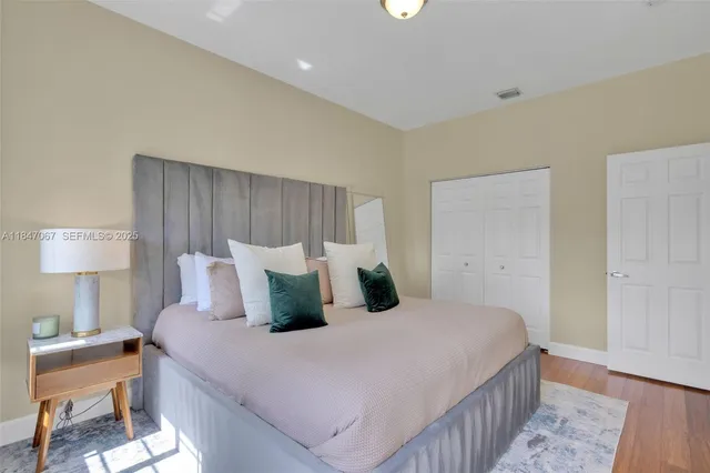 a bedroom with a bed and a lamp