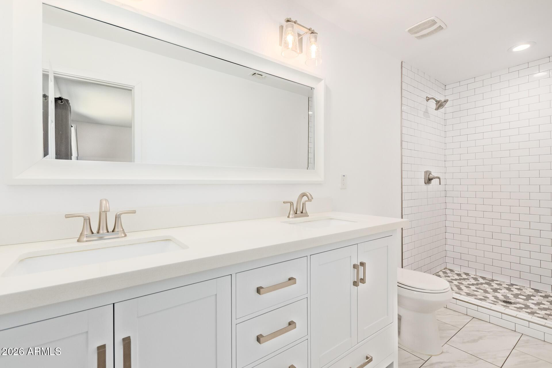 1809 East Concorda Drive Tempe, AZ 85282 - Photo 11 of 23 a bathroom with a sink a toilet and a mirror