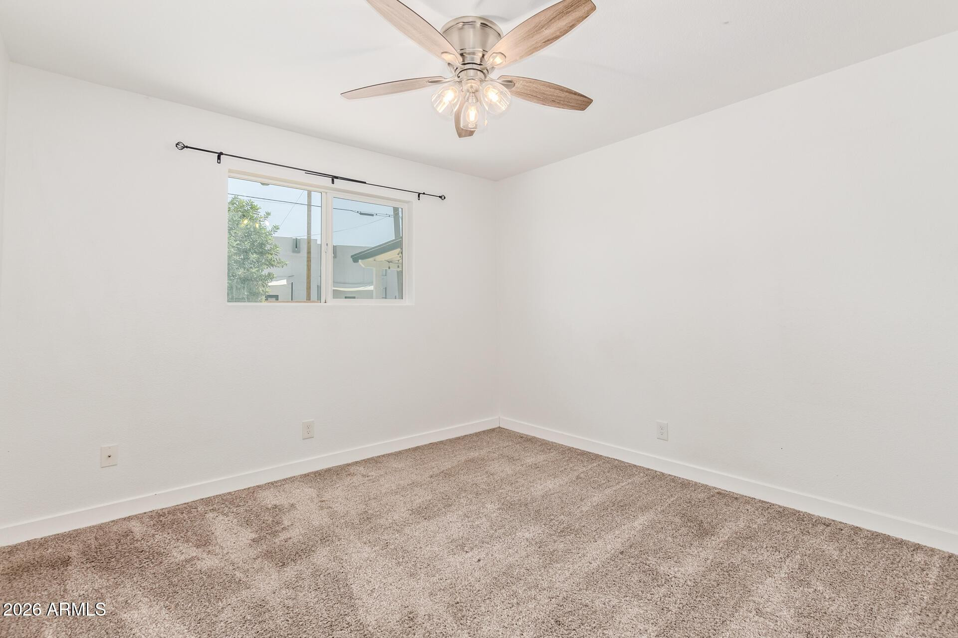 1809 East Concorda Drive Tempe, AZ 85282 - Photo 12 of 23 an empty room with a window and a fan