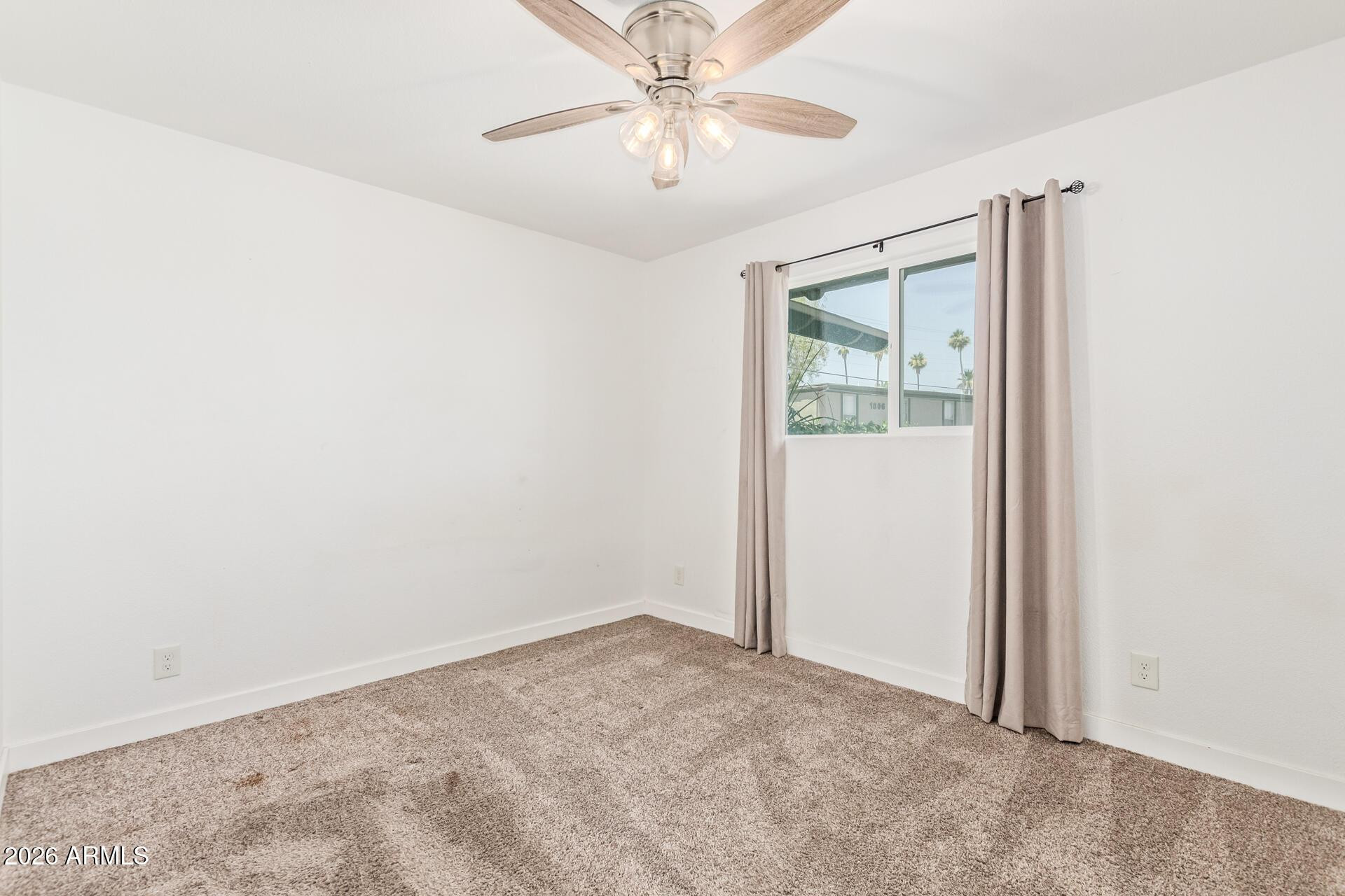 1809 East Concorda Drive Tempe, AZ 85282 - Photo 14 of 23 an empty room with windows and fan