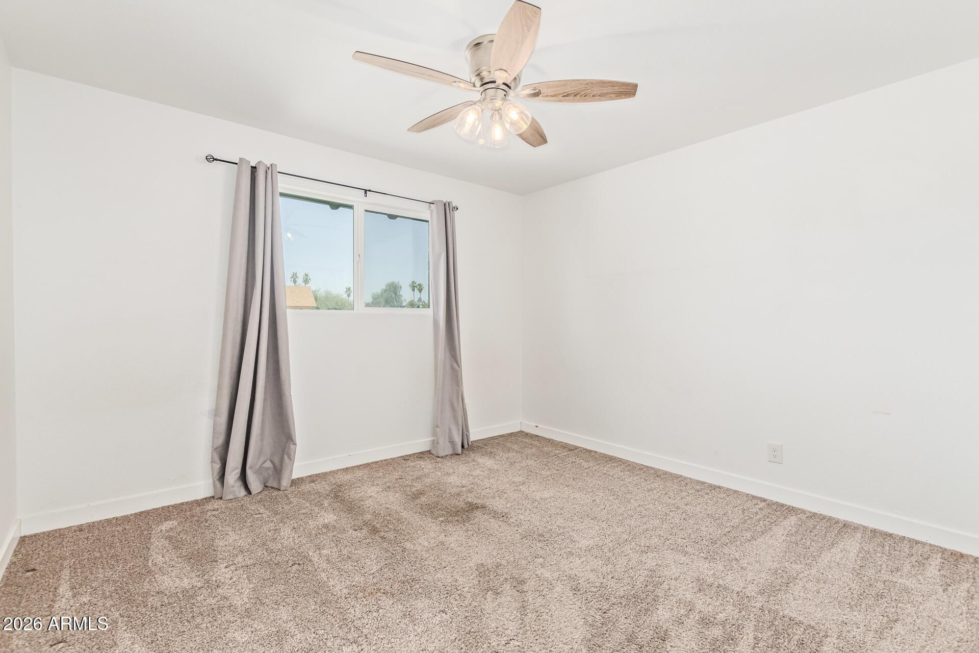 1809 East Concorda Drive Tempe, AZ 85282 - Photo 16 of 23 an empty room with windows and fan