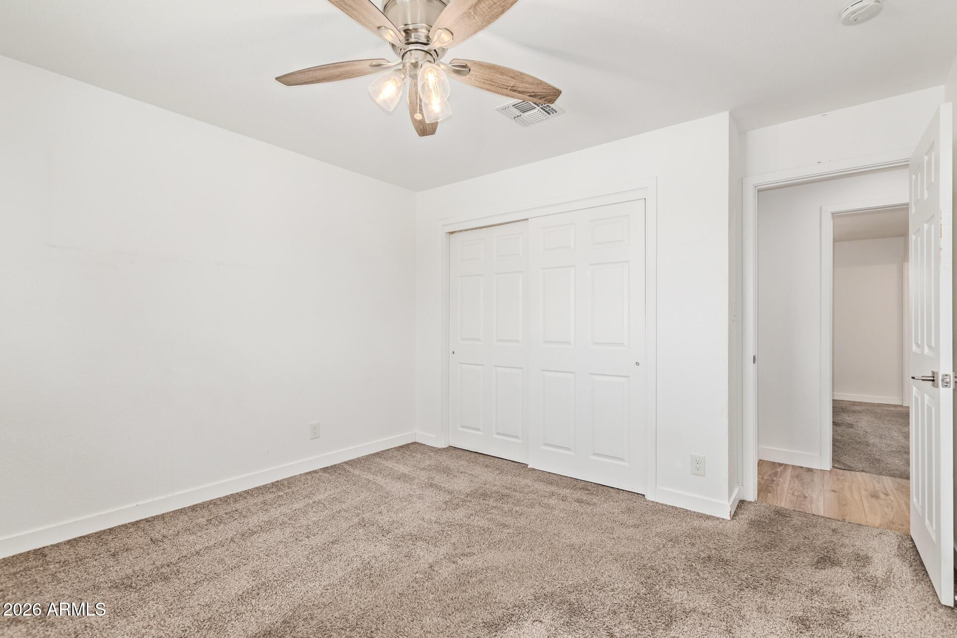 1809 East Concorda Drive Tempe, AZ 85282 - Photo 17 of 23 an empty room with a chandelier fan