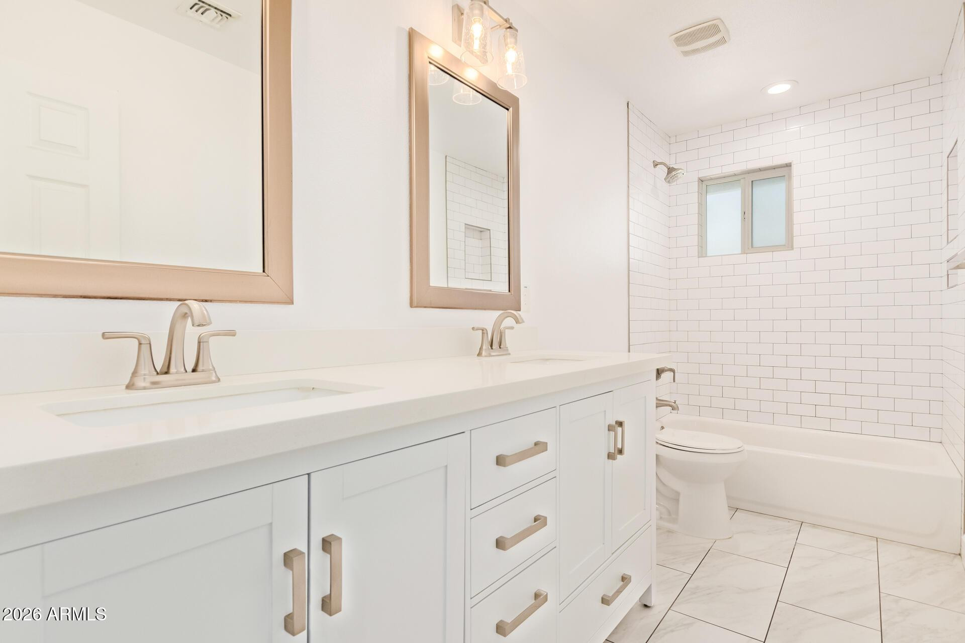 1809 East Concorda Drive Tempe, AZ 85282 - Photo 18 of 23 a bathroom with a double vanity sink a toilet and a bathtub