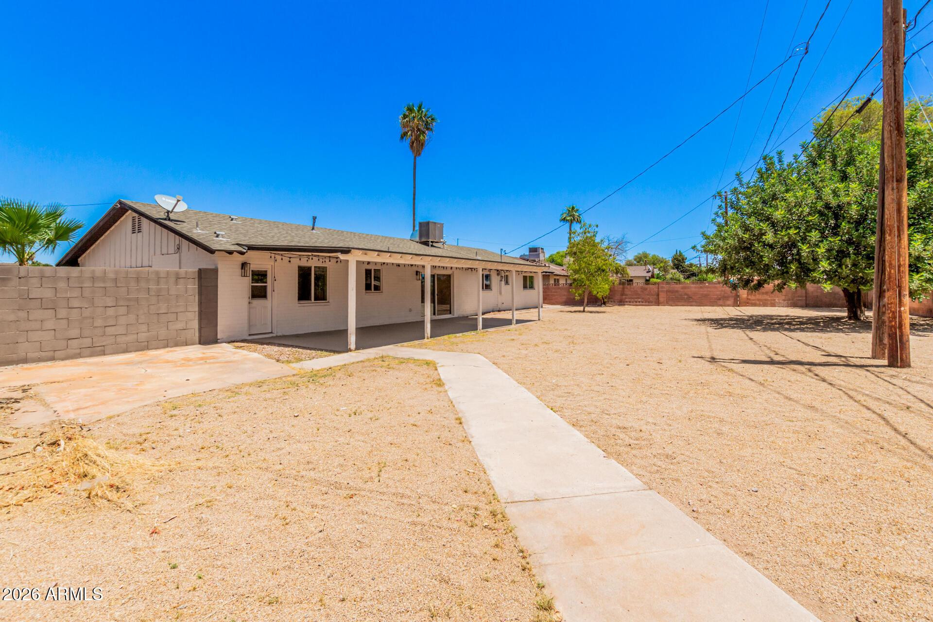 1809 East Concorda Drive Tempe, AZ 85282 - Photo 22 of 23 a front view of a house with a yard and potted plants