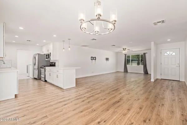 a view of a kitchen with furniture and wooden floor