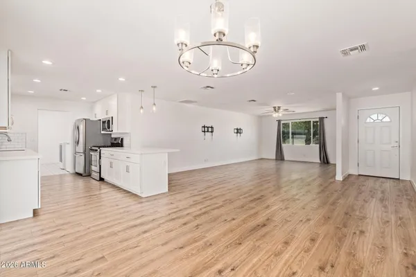 a view of a kitchen with furniture and wooden floor